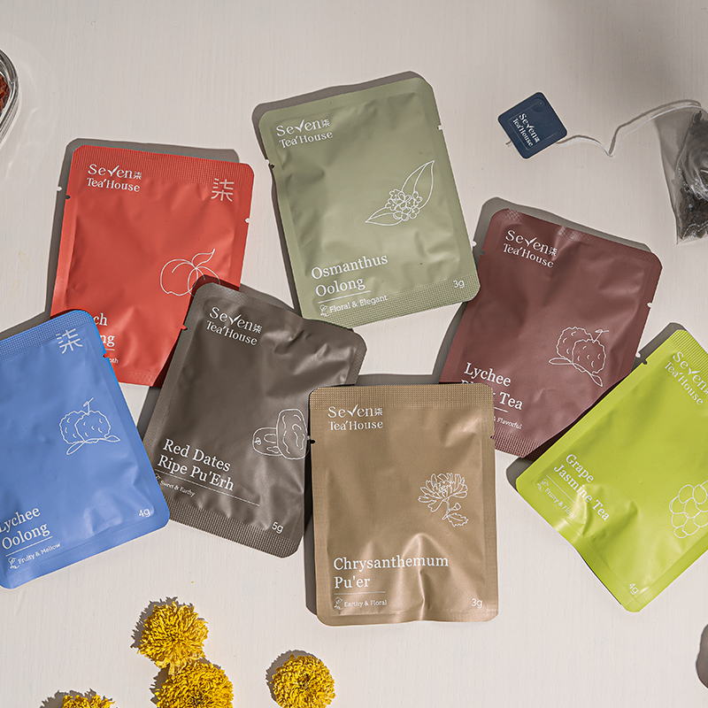 A variety of individually wrapped tea bags in a range of fruity and floral flavors