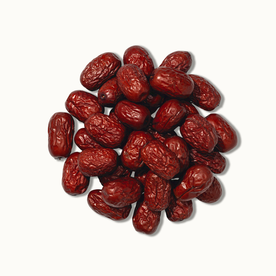 Pile of red jujube dates on a white background