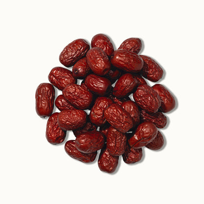 Pile of red jujube dates on a white background